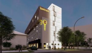Rendering einer Seitenansicht des Ipartment Stuttgart beleuchtet bei Nacht